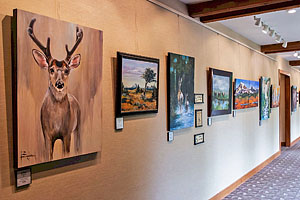 Long corridor with artwork hanging along one wall.