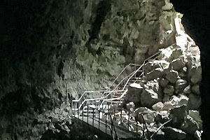 Stairway winding down into the Lava River Cave with the entrance in the background.