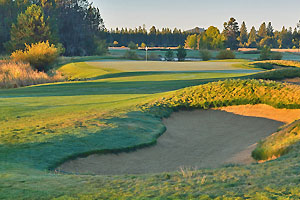 Fairway bunker with green and white flag in the distance.