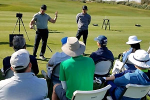 Students seated and listening to two standing instructors.