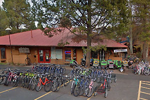 Storefront with rows of parked bicycles.