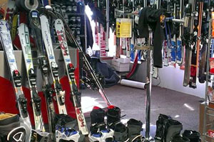 Store interior with rows of skis and boots for rent.