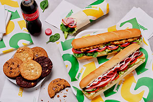 Two foot-long sub sandwiches and assorted cookies.